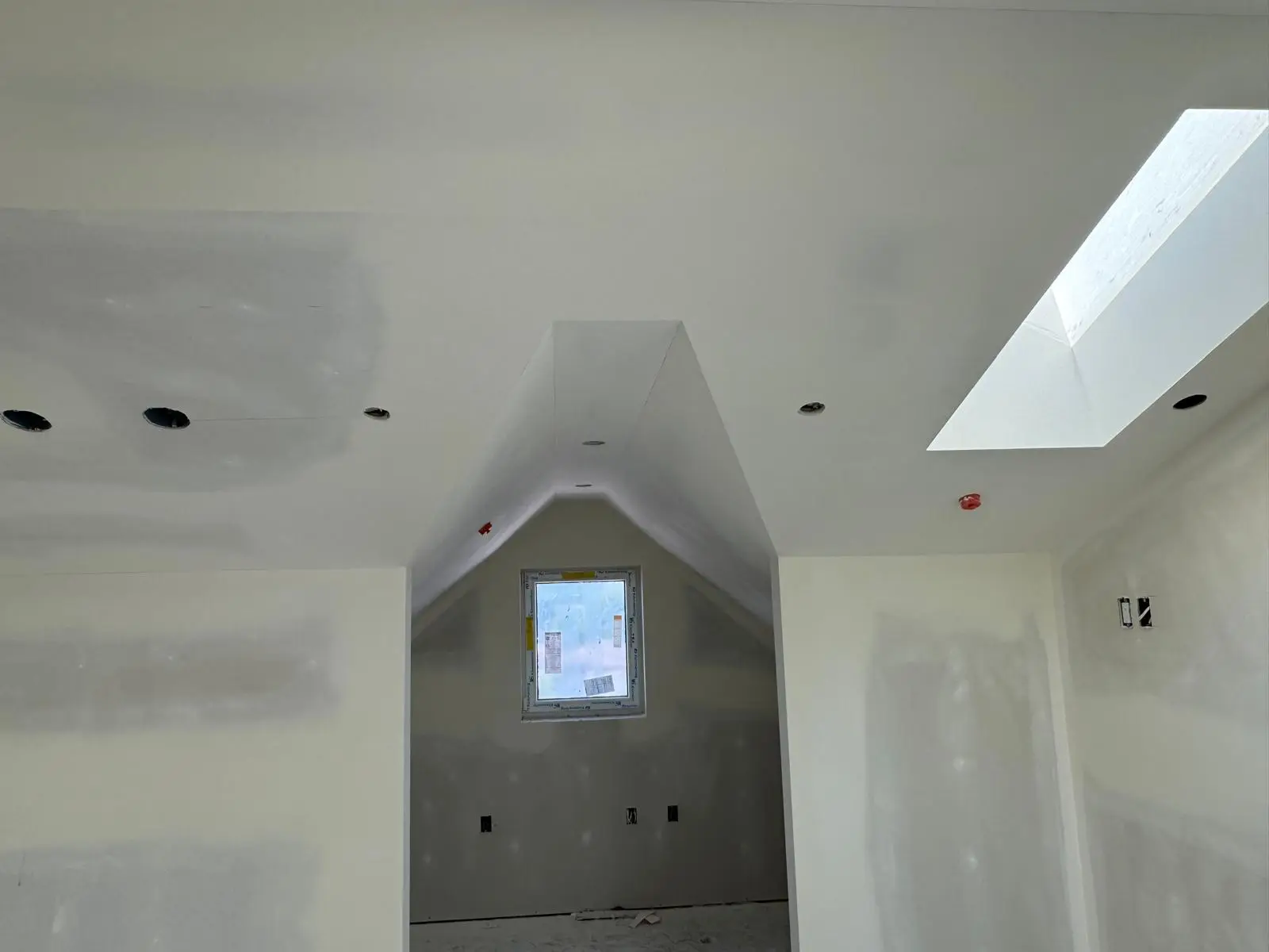 Dormer alcove with a pitched return and a window at the end, skylight well to the right.